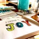 Colorful painting setup with 'Choose Joy' text, evoking a positive and creative vibe.